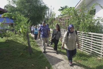 Walking through Nusa Ela village on Pulau Tiga to visit the solar power plant.