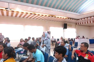 Audience members watch the panel discussion.