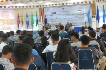 Audience members watch the panel discussion.